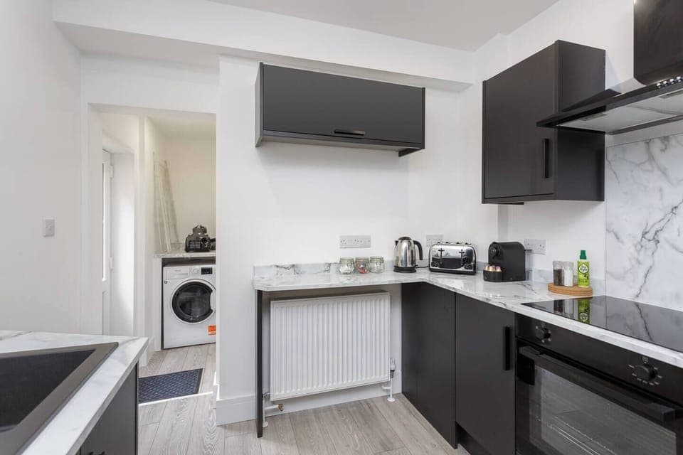 Chic cooking space with all the tools, plus a utility area to keep things fresh