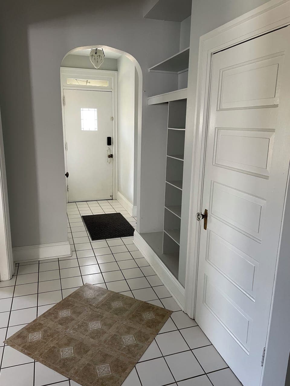 Entryway with two closets and build in shelves
