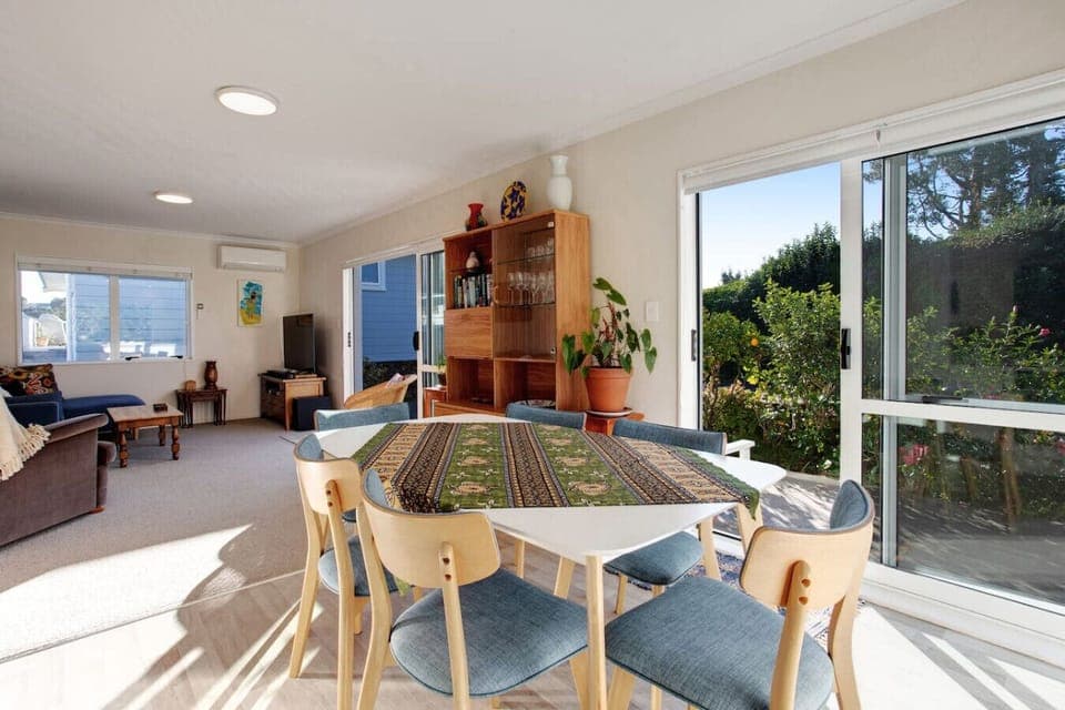 The dining table is located in the open-plan living spaces that include the kitchen and lounge.