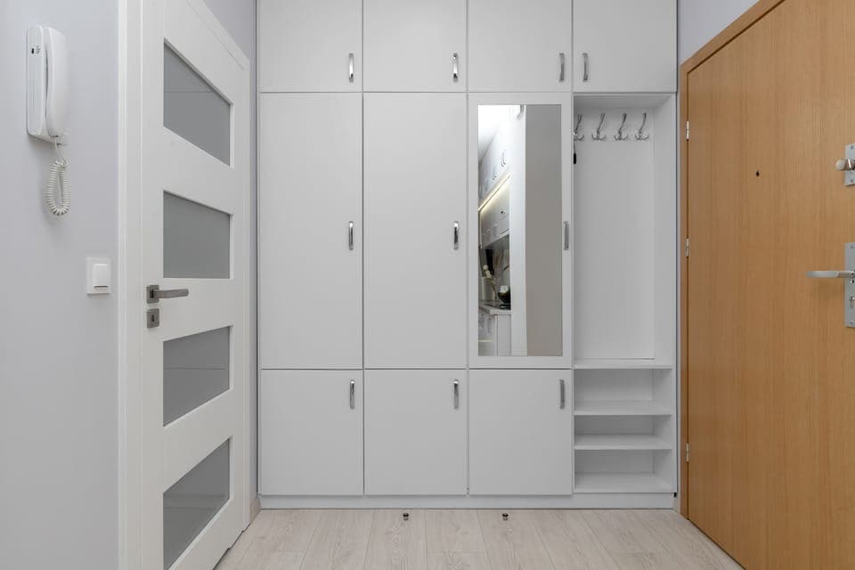 The practical hallway cabinetry provides ample storage and helps keep the space tidy.

