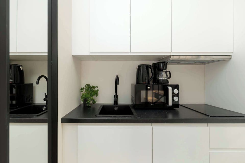 A modern kitchen with a coffee machine and induction hob makes meal prep quick and convenient.