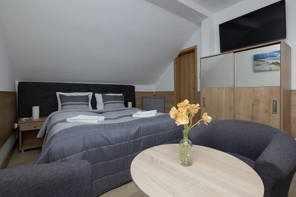 Flat-screen television in the stylish living area, where the guests can enjoy their favorite shows.