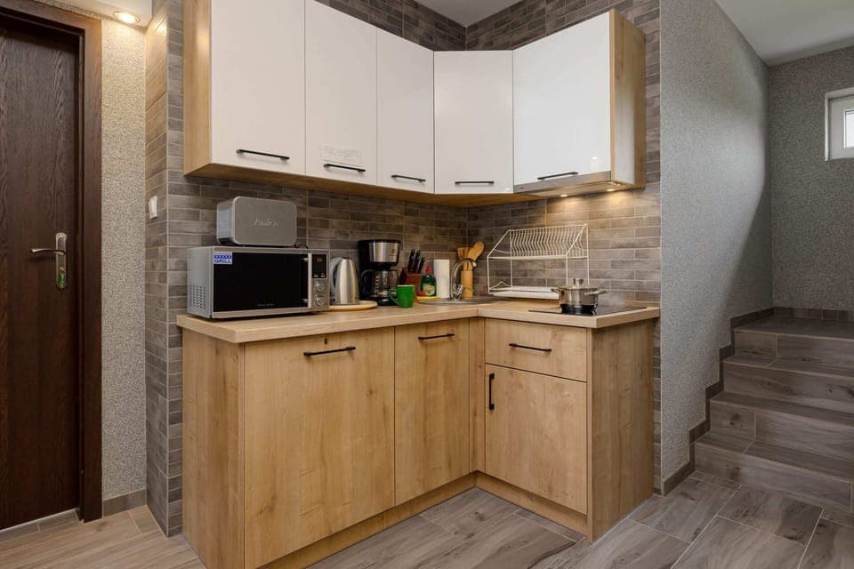 The fully equipped kitchenette in the living area includes everything you need for a home-cooked meal.