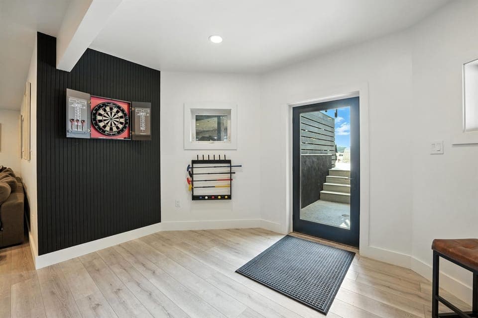 Dart board and access to the patio and pool from the home's lower level