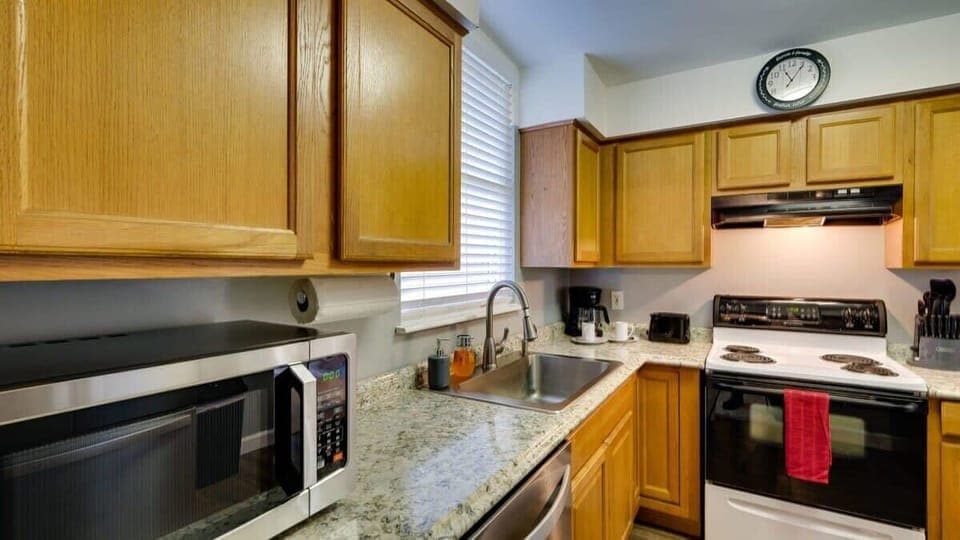 Fully equipped kitchen with essential appliances and cabinet space.