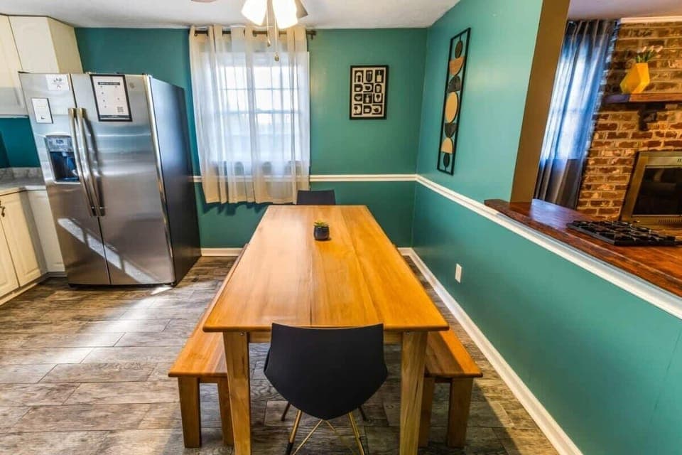 Vibrant dining space with live-edge wooden table and bench seating.