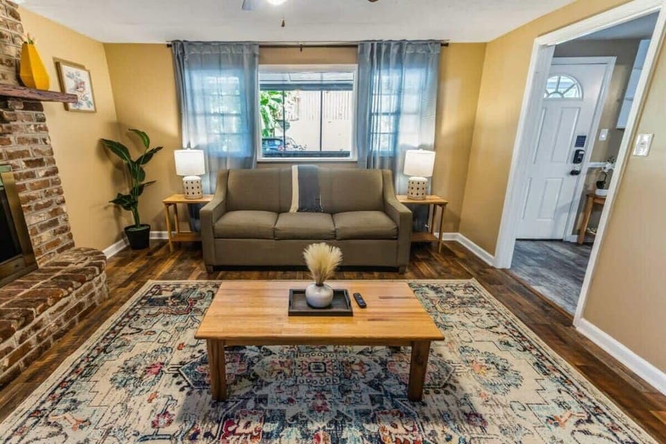Bright living room with comfortable seating and large windows bringing in natural light.