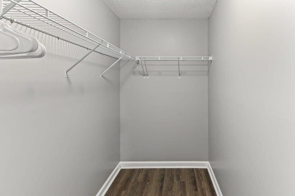 Walk-in closet with plenty of hanging space and shelving.