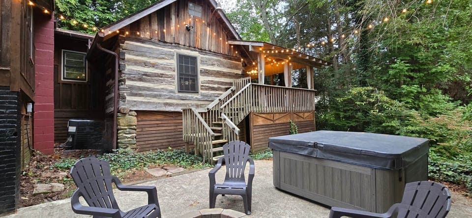 The original 1800s structure sits in the back of the property with large porch area attached.