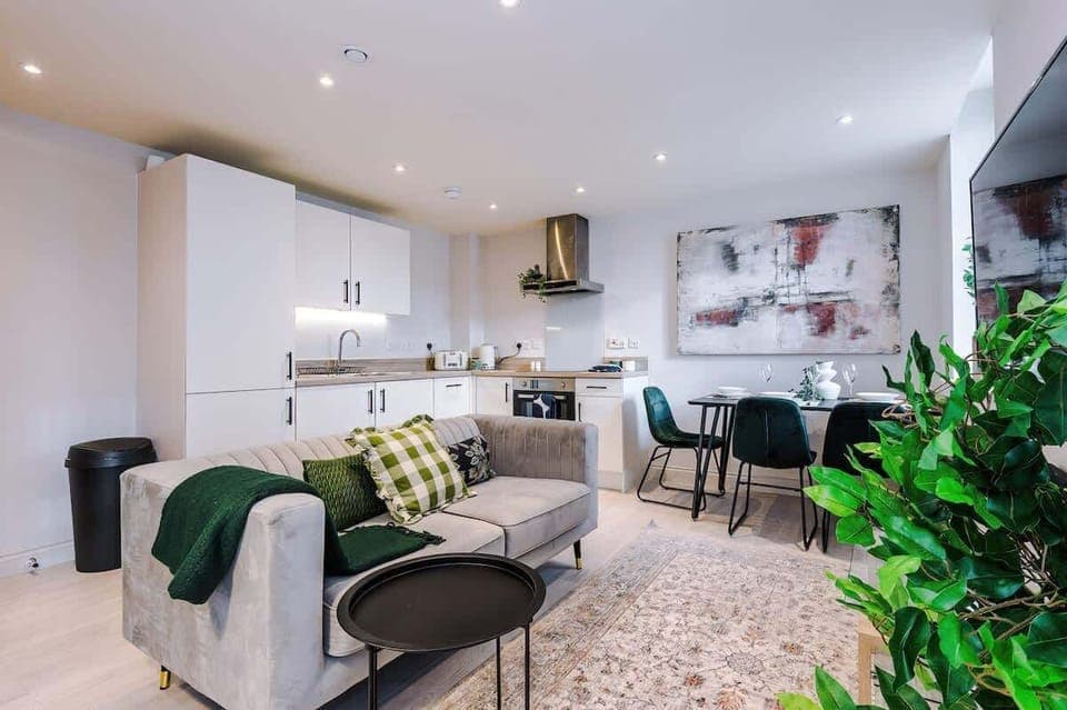 Bright living room with a comfy sofa, smart TV with Netflix, and large windows. Includes 2 fold-out chair beds that convert into single beds, offering extra sleeping space for up to 2 guests. Stylish wall art adds a modern touch.








