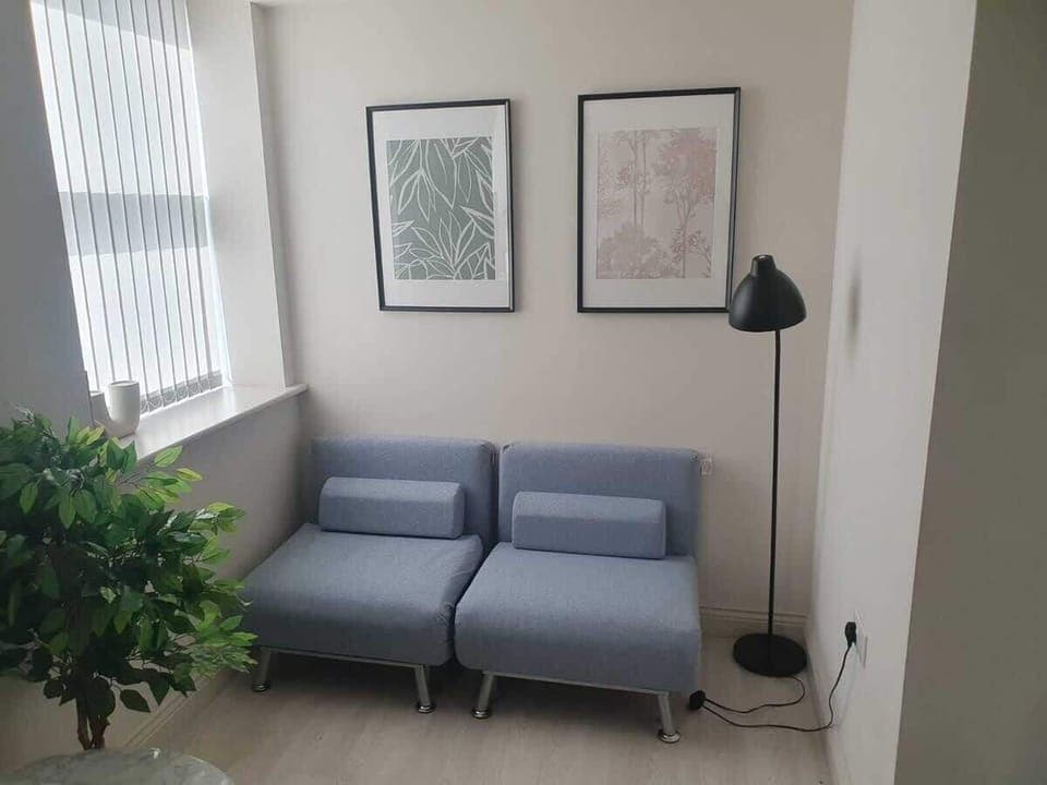 Bright living room with a comfy sofa, smart TV with Netflix, and large windows. Includes 2 fold-out chair beds that convert into single beds, offering extra sleeping space for up to 2 guests. Stylish wall art adds a modern touch.
