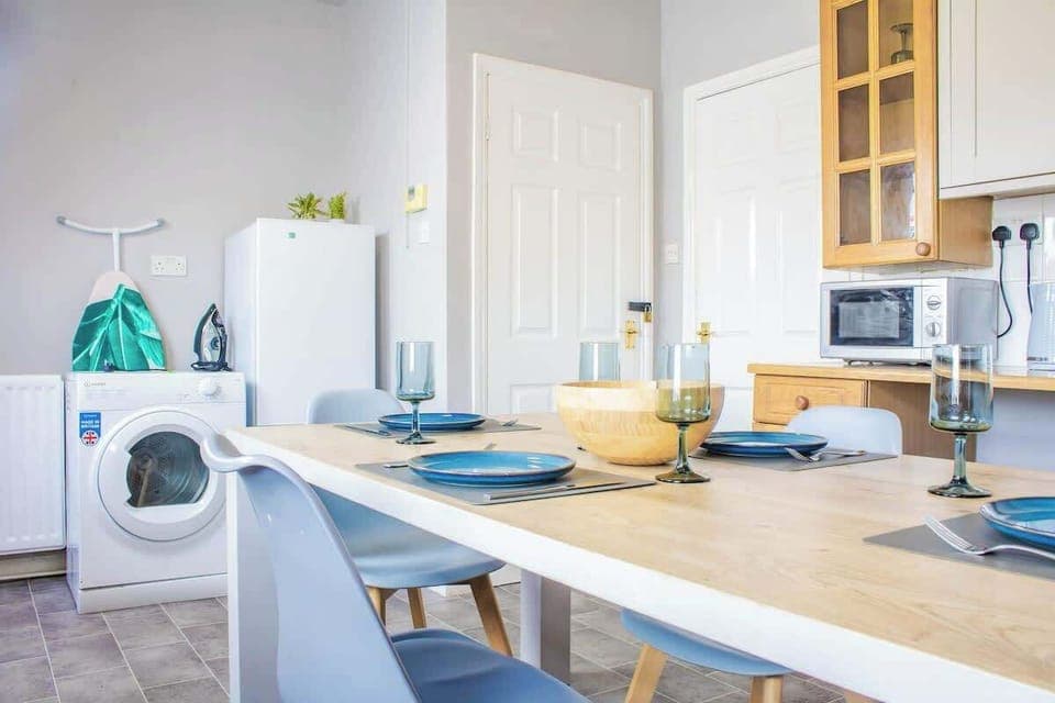 An elegant dining area with a stylish table, comfortable chairs, and ambient lighting, perfect for meals and gatherings.