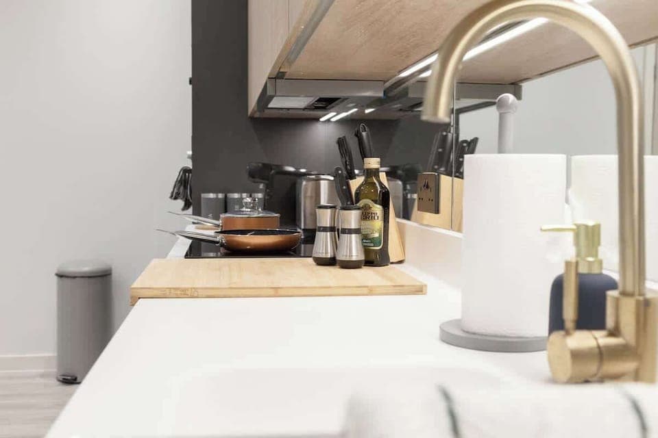 A kitchen is equipped with essential appliances and fixtures for cooking, preparing, and storing food.