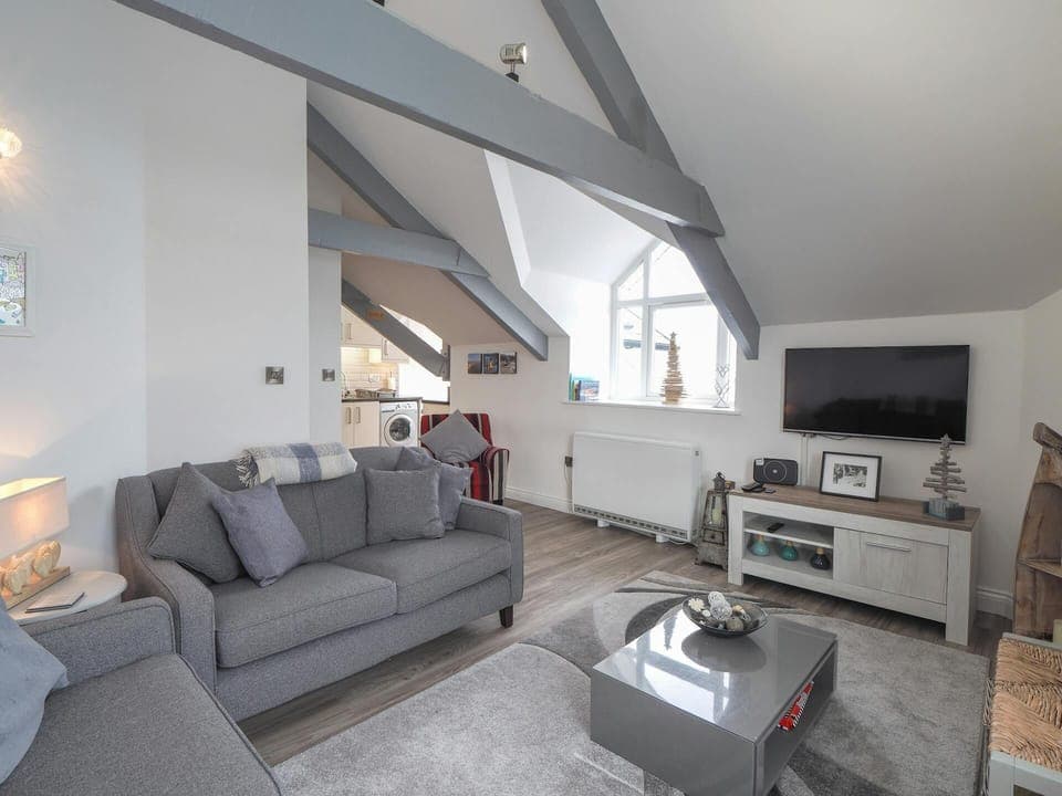 Sofas, coffee table, TV on the wall and cabinet