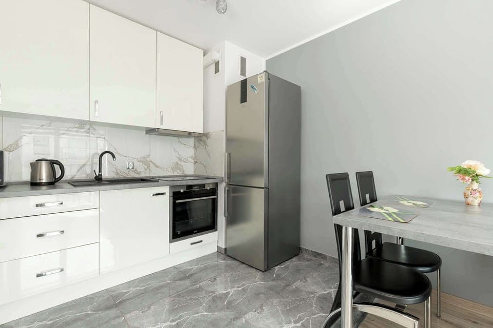 The sleek design of the kitchenette blending seamlessly with the living area.
