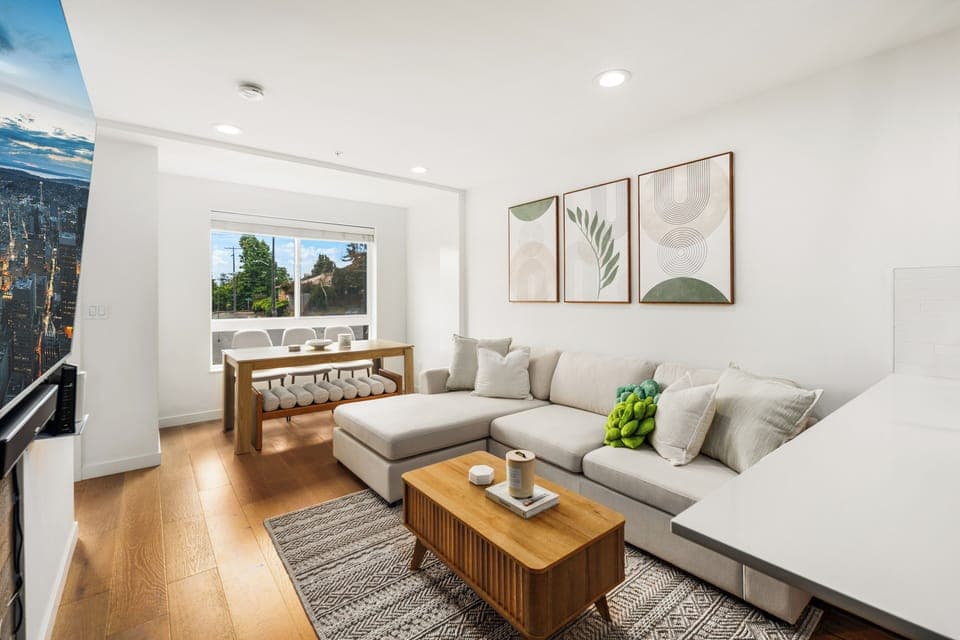 Open floor living and dining room along with a 65" Samsung smart TV