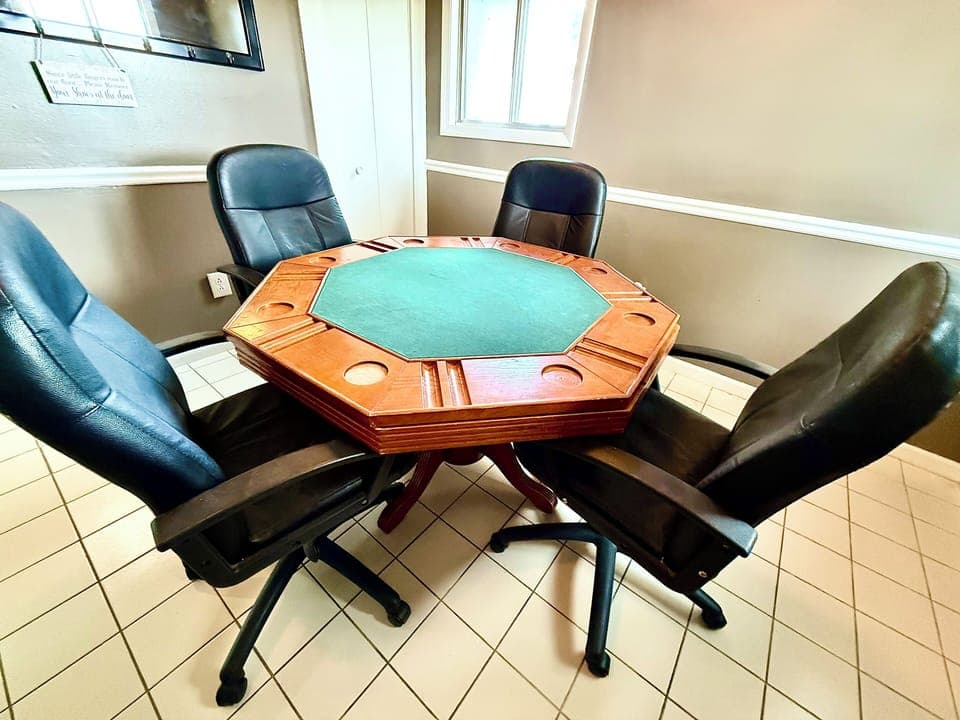 Challenge friends to cards at this dedicated poker table with leather chairs—perfect for evening fun or a rainy day indoors.