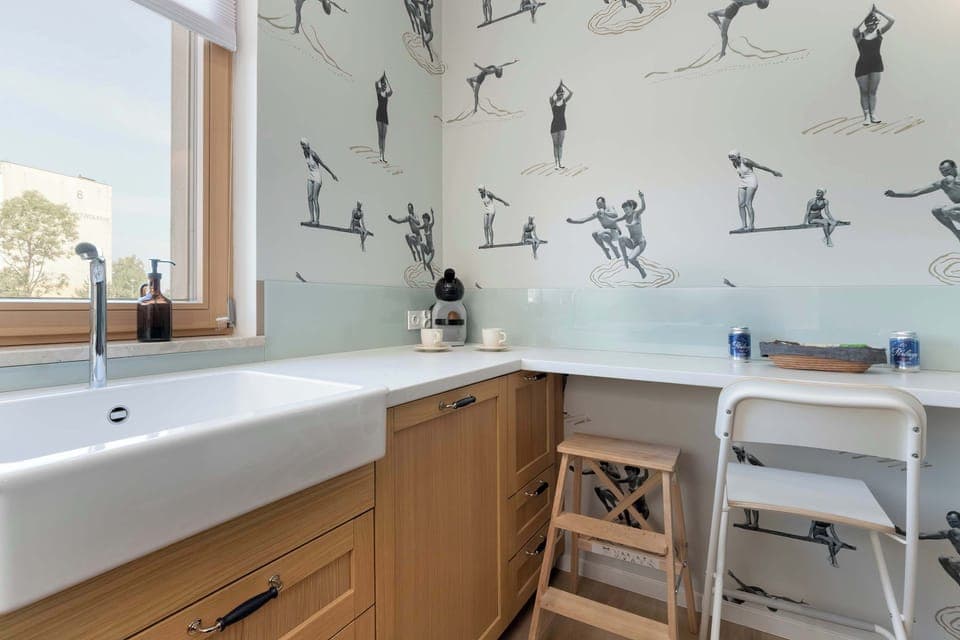 The kitchen's sleek design includes all necessary cookware and utensils.