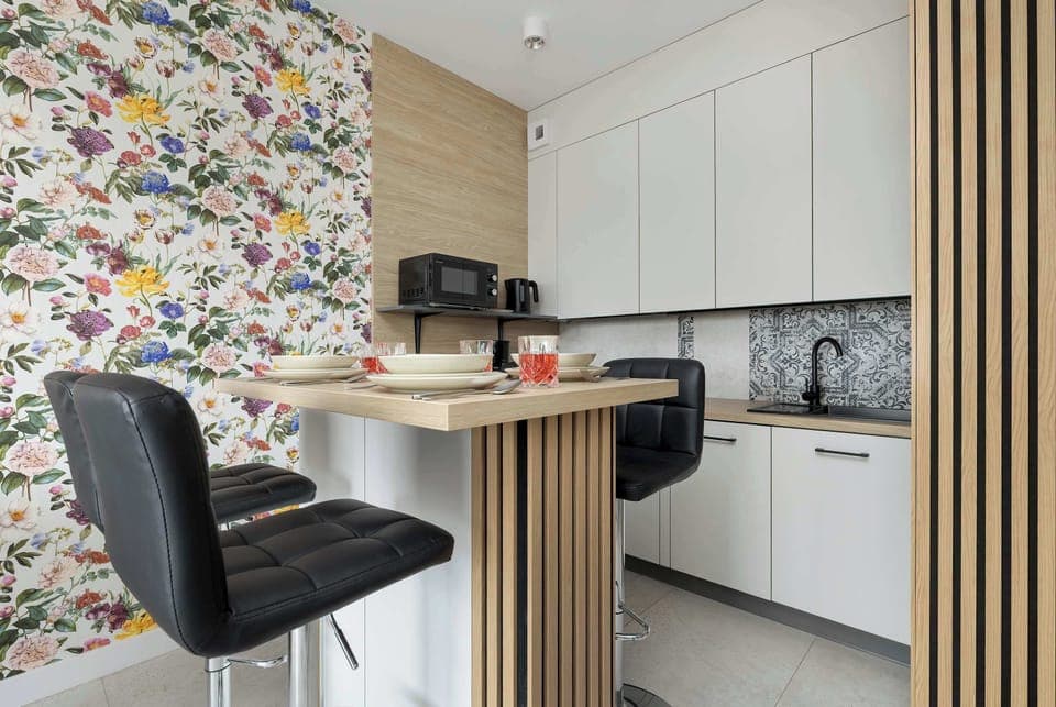 Fully equipped kitchenette with kitchen appliances and dining area.