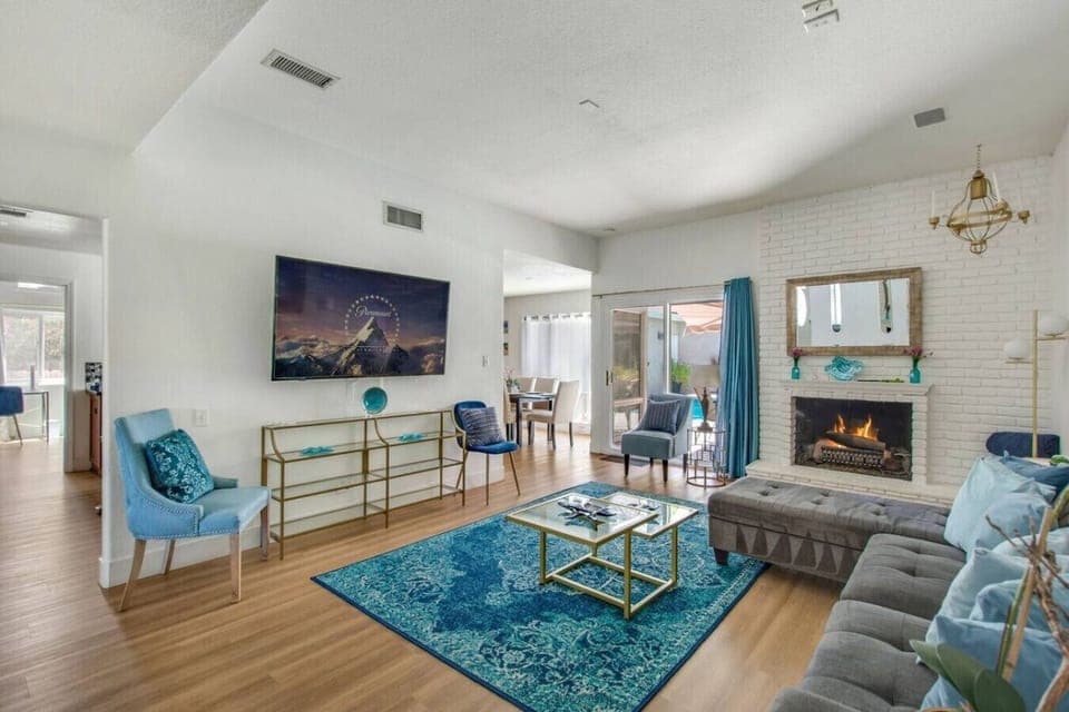 ather in the open concept living room, complete with comfortable couches, a gas fireplace, Smart TV, and sofa sleeper.