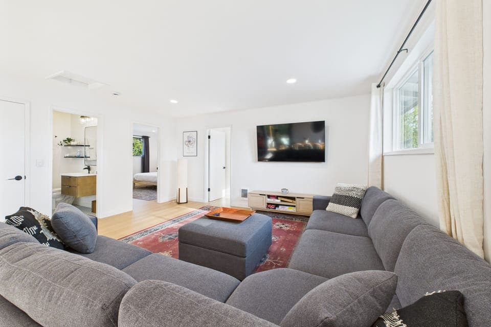 Spacious open living room on main level with 65" smart TV. 