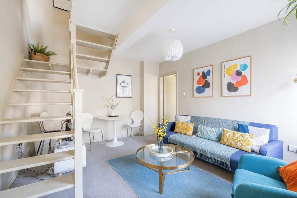 An angle of the living room furnished with sofa and TV