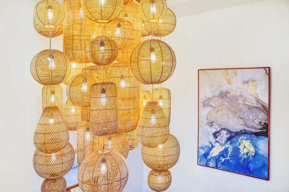 Warm wicker lights and abstract art for cozy elegance