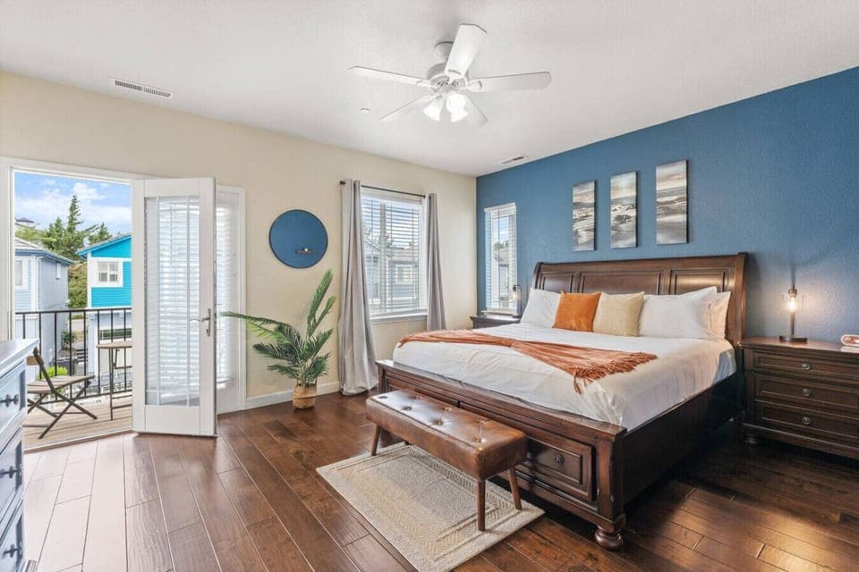 Wake up refreshed in this spacious primary suite featuring a king bed, private balcony access, rich wood floors, and calming decor—your perfect retreat after a day of adventure.