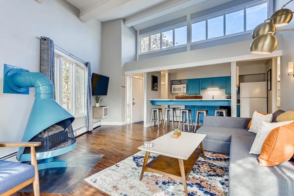 Open living room with vaulted ceiling and eight overhead windows for great light