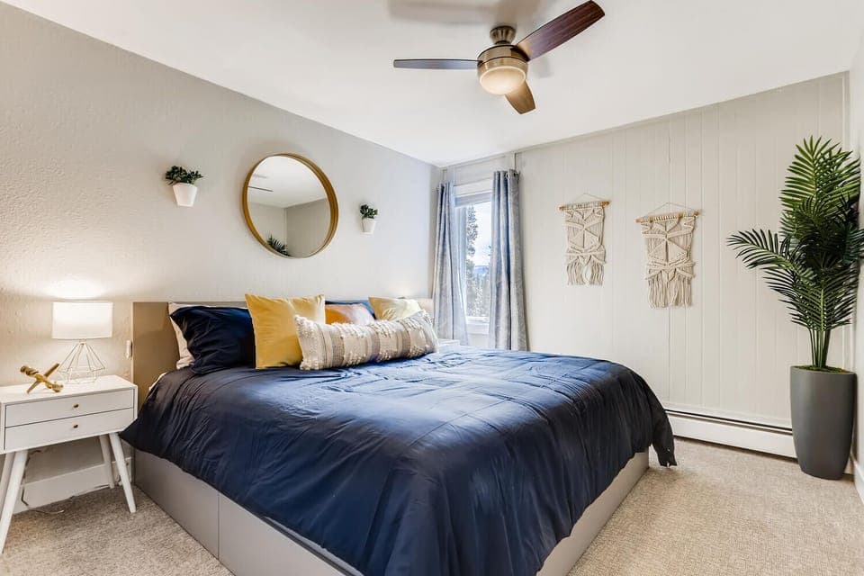 Bedroom with king bed, ceiling fan, closet