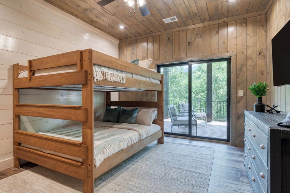 Bedroom 4 features a queen bunk bed, a TV, and a closet.