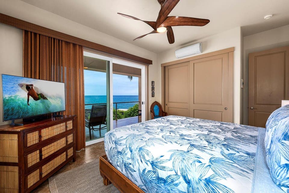 Soft blues echo the sea beyond the window, and a ceiling fan keeps island breezes moving when guests turn in for the night.