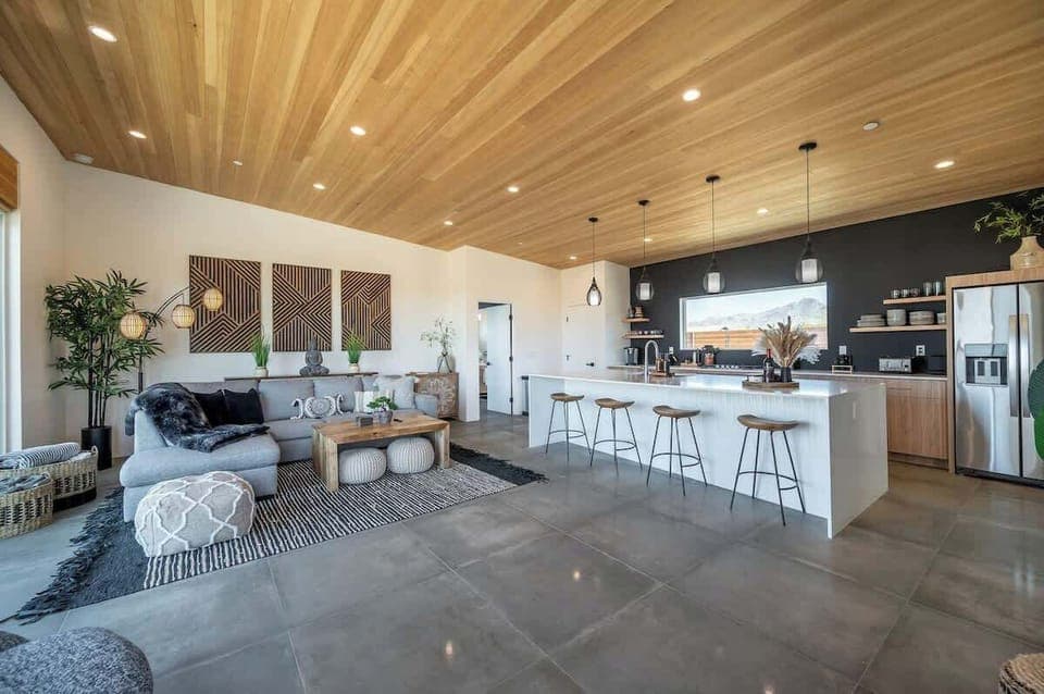 Turkish cotton towels for the outdoor shower and hot tub can be found next to the couch, along with outdoor blankets