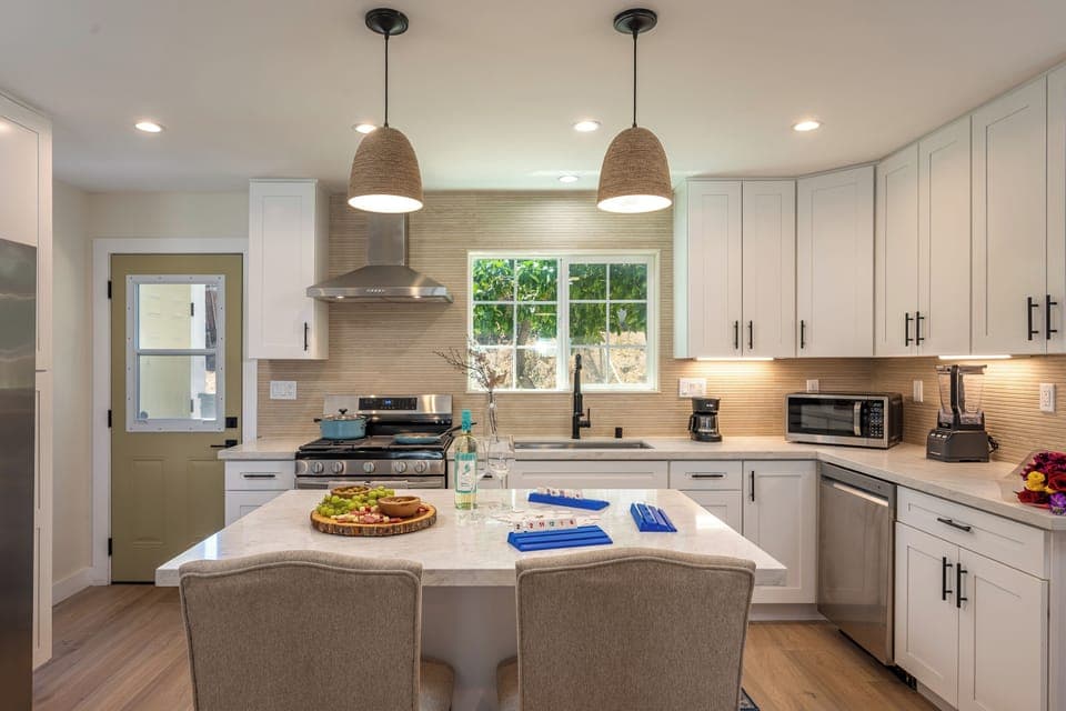 Modern kitchen with island seating, stainless appliances, and style