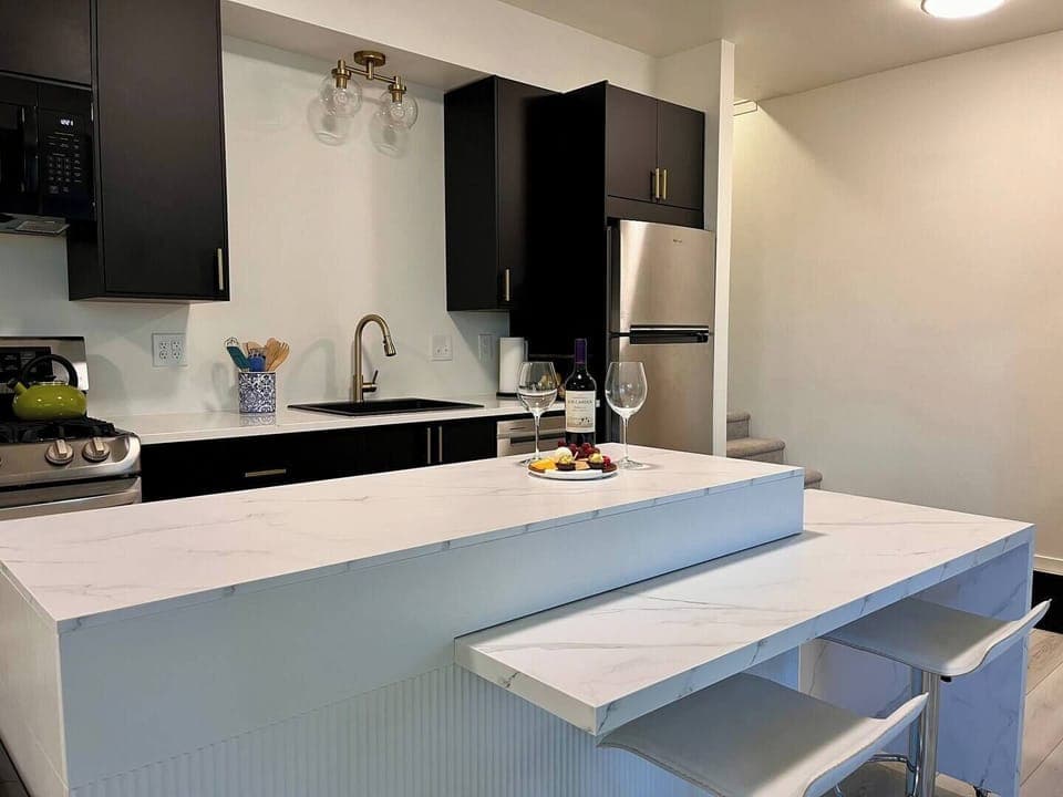 Kitchen with center island that converts to a dining table