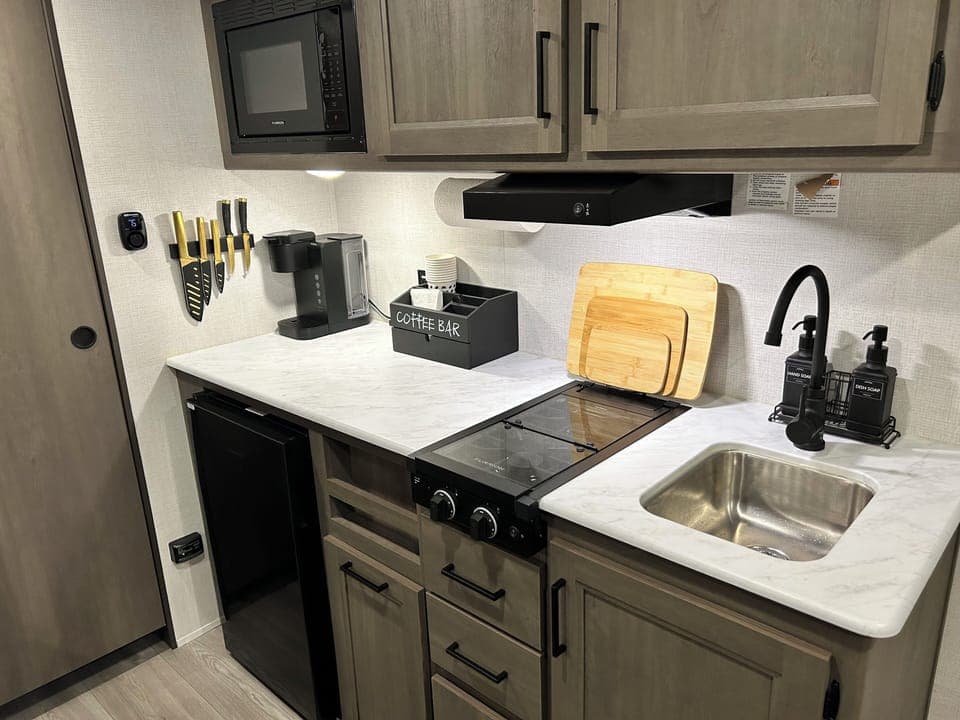 The kitchen, with a stove, fridge and Keurig coffee maker.