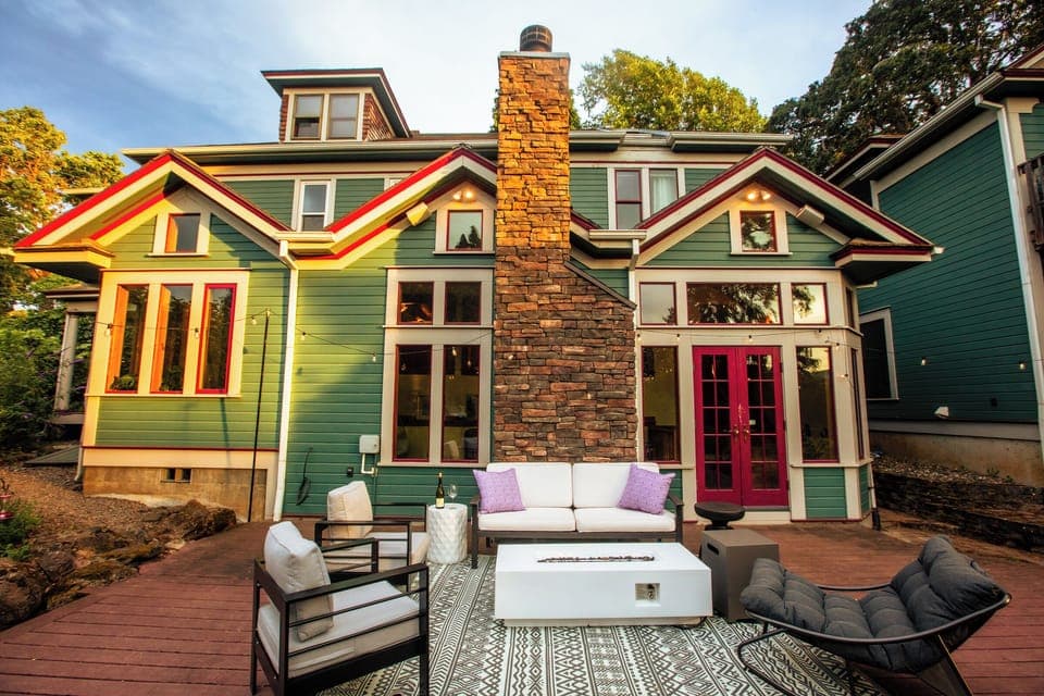 Back Porch with fire pit coffee table, festive string lights and comfortable seating.