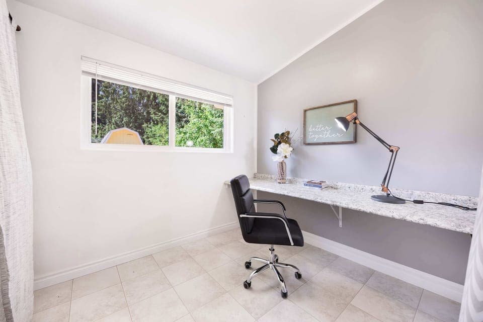 Your marble-topped desk with adjustable task lighting for focused work sessions.