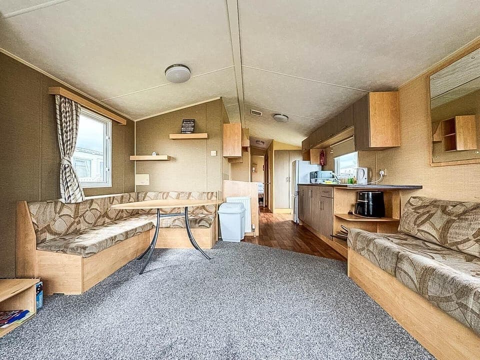 Relax in the comfortable living room of your holiday home, making it the perfect coastal escape for pet owners seeking comfort and convenience.