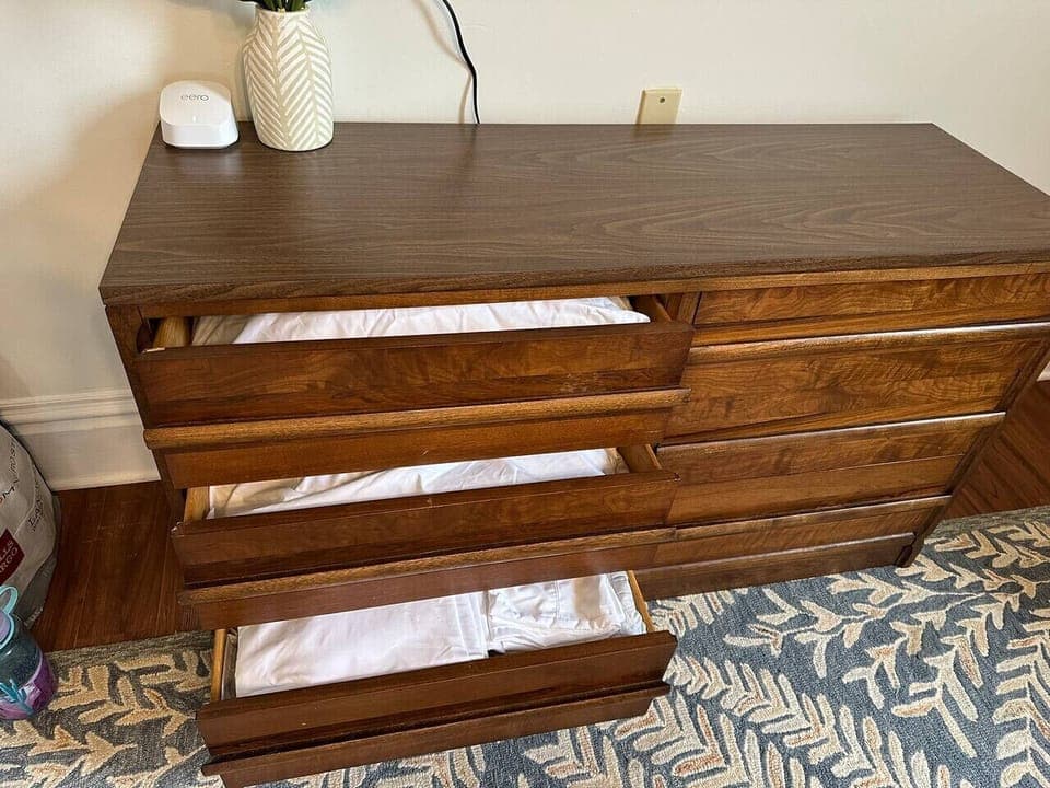 Extra pillows and bedding for sofa bed underneath TV