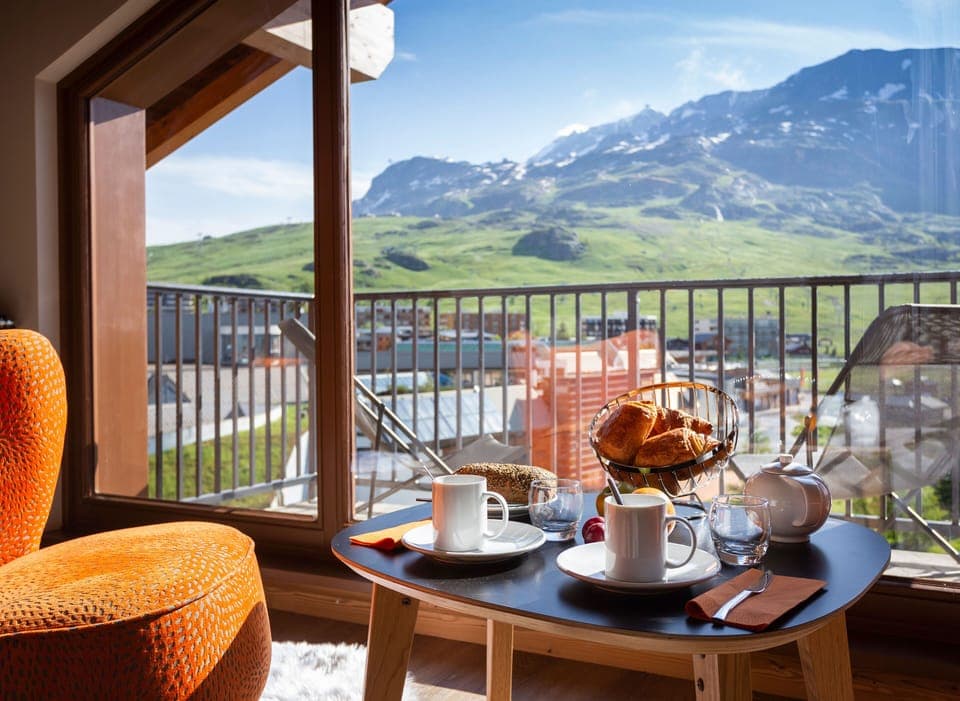 Start your morning with fresh coffee and a jaw-dropping view of the peaks from your private balcony.