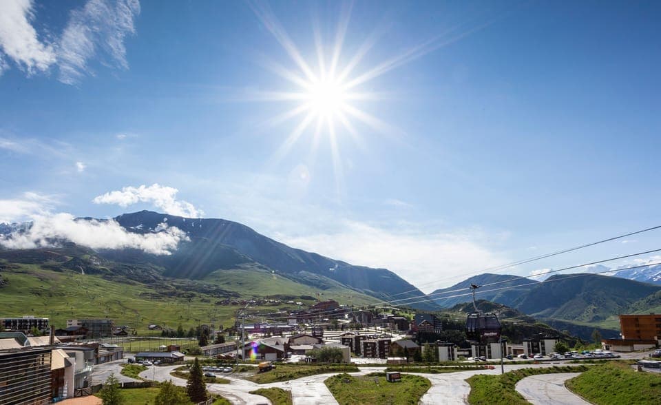 Expansive views over green hills and blue skies from your sunny alpine location.