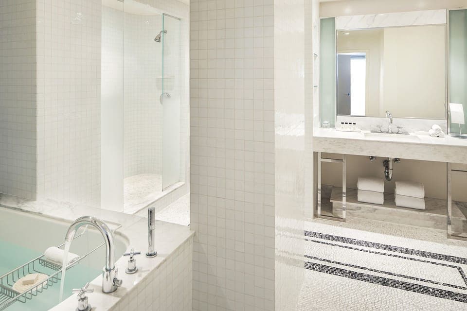 Refresh in the spa-bright bath with tub and glass shower.