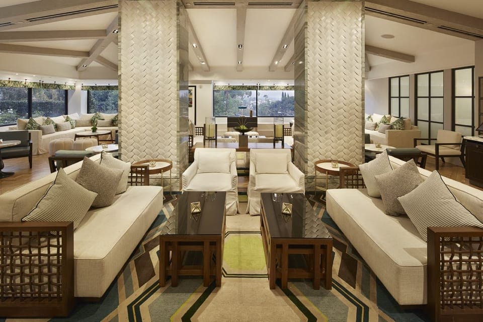 Sink into serene sofas and enjoy sunlit views beyond.