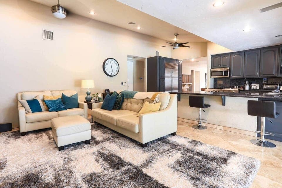 Buttery leather couches and open kitchen concept.