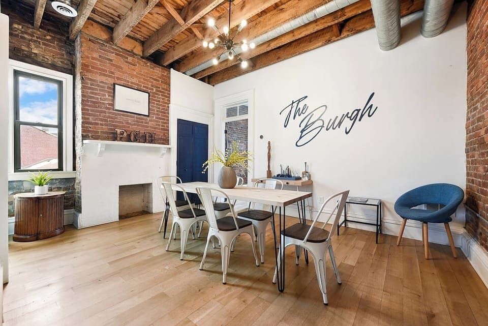 Enjoy a huge dining space with a long table, six chairs, and an extra cushioned seat. The room’s simple yet elegant design creates the perfect ambiance for meals, whether it's a casual breakfast or a special gathering with family and friends.