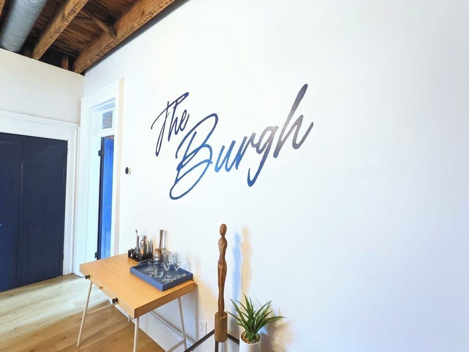 A beautifully designed dining space with a long table, six chairs, and an extra cushioned seat. This spacious yet cozy area, with its simple elegance, is ideal for family dinners, friendly get-togethers, or relaxing moments over your favorite meals.