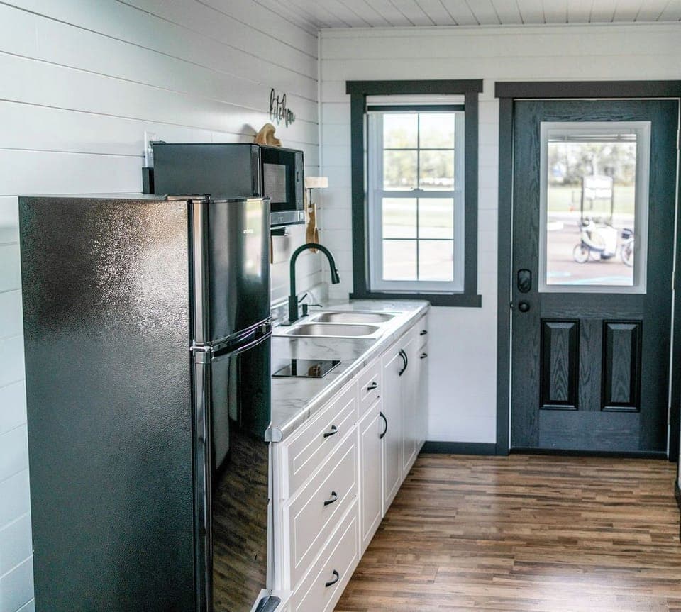 The kitchenette is equipped with a microwave, refrigerator, and hot plate.