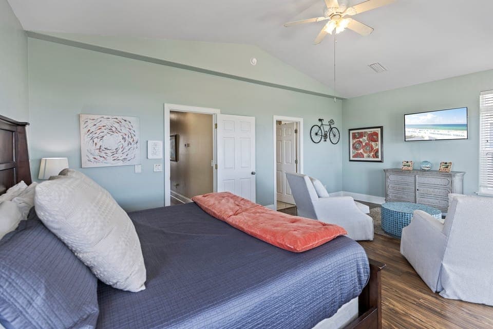 Sink into soft linens while gentle breezes from your ceiling fan keep you comfortable in this serene bedroom.
