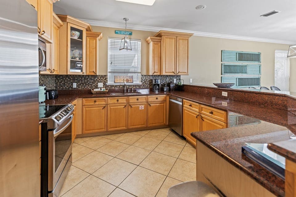 Your fully equipped kitchen welcomes culinary adventures with granite countertops, stainless steel appliances, and warm wood cabinetry for memorable meal preparations.